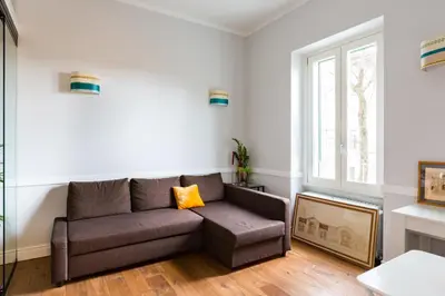 a living room with a couch and a window at Guest House Poerio88 in Rome
