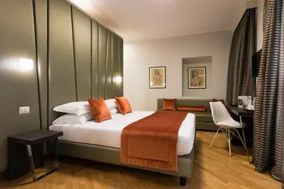 a bedroom with a large bed and a couch at Vittoriano Suite in Rome