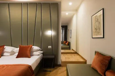 a bedroom with a bed and a couch in a room at Vittoriano Suite in Rome