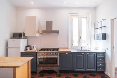 a kitchen with a stove and a sink at HC - Sunny Apartment in Testaccio! in Rome