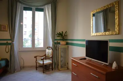 a living room with a television and a chair at I Petali Guest House in Rome