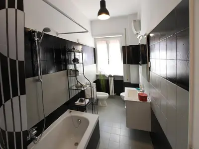 a bathroom with a tub and a sink and a toilet at Marina Home in Rome