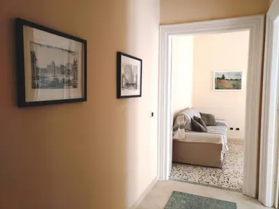 a living room with a chair and a mirror at Capital Flat 9/b in Rome