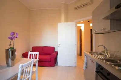 a kitchen and living room with a red couch at Capital flat 9-A in Rome