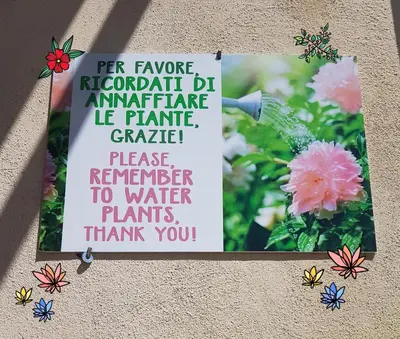 a sign on the side of a building with flowers at Robta's Dream Home in Rome