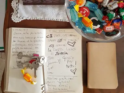 a book with a note and a bowl of candy at Robta's Dream Home in Rome
