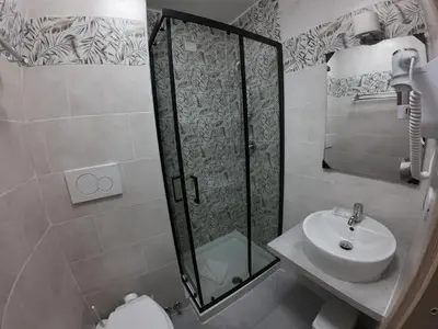 a bathroom with a shower and a sink and a toilet at KayDee GuestHouse in Rome