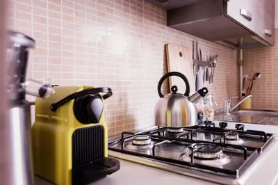 a tea kettle sitting on top of a stove in a kitchen at TrastevereHome - Peretti Rome in Rome