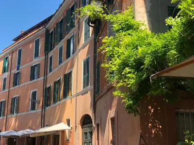 an old building with a tree in front of it at TrastevereHome - Paglia House of 17Century in Trastevere in Rome