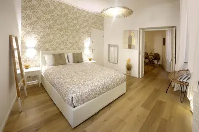 a bedroom with a bed and a hallway with a table at Buongiorno Colosseo in Rome