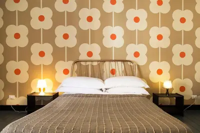 a bedroom with a bed with a floral wallpaper at TrastevereHome - Ripa Rome Trastevere Home in Rome