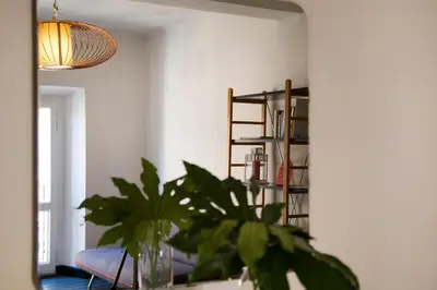 a living room with a plant and a book shelf at TrastevereHome - Ripa Rome Trastevere Home in Rome