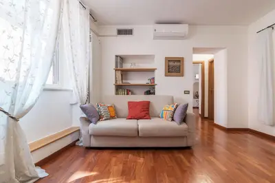 a living room with a couch with pillows on it at Casa Zeffiro - FromHometoRome in Rome