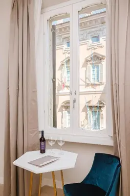 a table with two wine glasses and a window at Rhea Silvia Luxury Navona in Rome