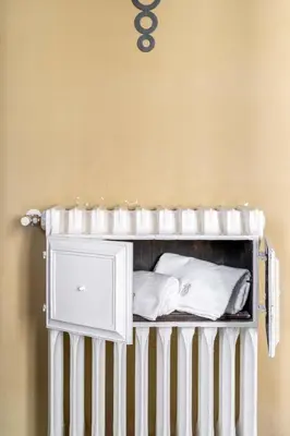 a white crib with white pillows in a room at Popologrande Apartment in Rome