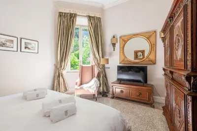 a bedroom with two beds and a mirror and a television at Popologrande Apartment in Rome