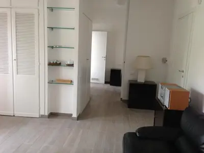 an empty living room with a couch and a lamp at Megi San Peter Apartment in Rome