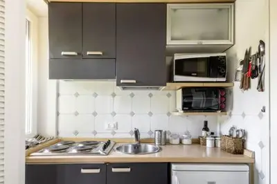 a kitchen with a sink and a microwave at Megi San Peter Apartment in Rome