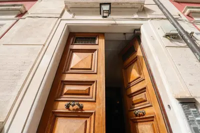 a wooden door in the side of a building at Labicana Apartment in Rome