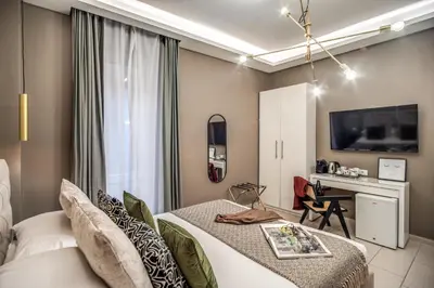 a hotel room with a bed and a desk at Borgognona Rooms in Rome
