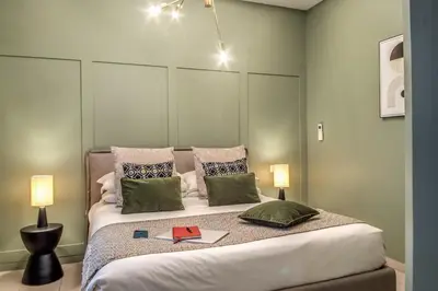 a bedroom with a large bed with two lamps at Borgognona Rooms in Rome