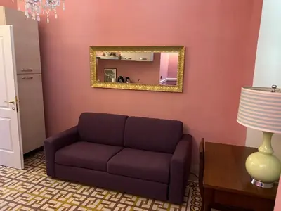 a living room with a couch and a mirror at Guest House Biondi in Rome