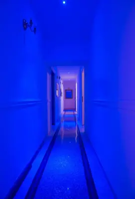 an empty hallway with blue lights in a room at Guest House Biondi in Rome