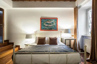 a bedroom with a bed and a painting on the wall at The Pantheon view in the heart of Rome in Rome