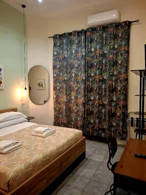 a bedroom with a bed with a curtain and a table at Double B Ferruccio I in Rome