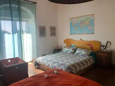 a bedroom with a bed and a large window at San Saba Rooftop Garden in Rome