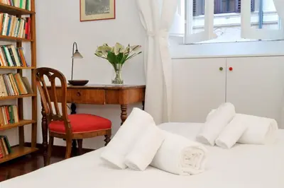 a bedroom with two beds and a desk and a chair at RomeAsYouLike-Monti Experience 295 in Rome