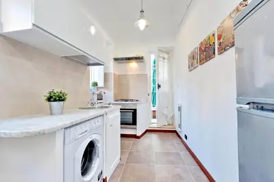 a white kitchen with a washer and dryer at RomeAsYouLike-Monti Experience 295 in Rome