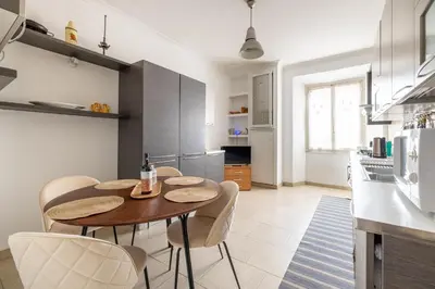 a kitchen with a table and chairs in a room at Domus Mari in Rome