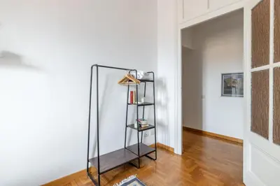 a room with a mirror and a shelf at Domus Mari in Rome