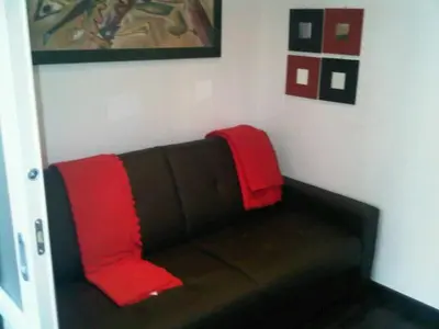 a couch with two red pillows on top of it at Mammamia in Rome