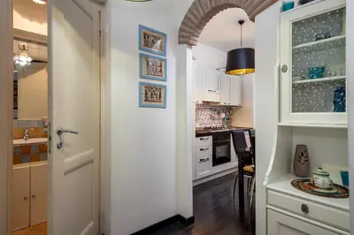 a kitchen with white cabinets and a white door at Mammamia in Rome