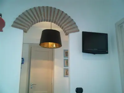 a room with a tv and a lamp and a ceiling at Mammamia in Rome