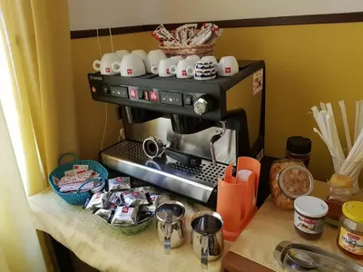 a kitchen counter with a coffee maker on top of it at Domina Romae B&B in Rome