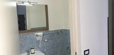 a bathroom with a mirror and a sink at Domina Romae B&B in Rome