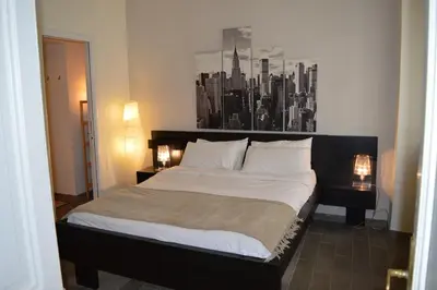 a bedroom with a bed with a black and white picture on the wall at Banchi Vecchi NY in Rome