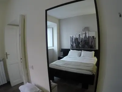 a mirror reflecting a bed in a bedroom at Banchi Vecchi NY in Rome