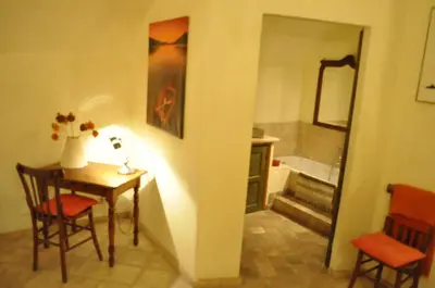 a room with a table and a bathroom with a tub at Onofrio Flat in Rome
