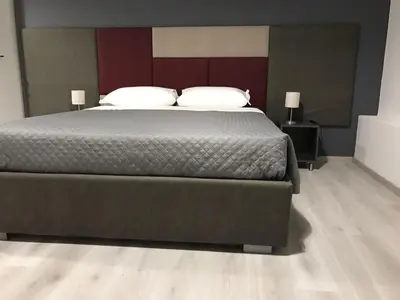a bedroom with a large bed and two lamps at Sensation House in Rome