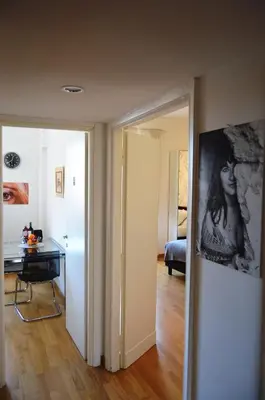 a room with a hallway with a desk and a painting at Blue Star luxury apartment San Giovanni - Colosseo in Rome