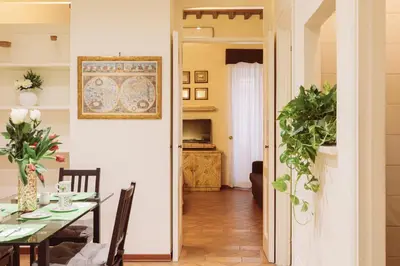 a kitchen and dining room with a table and chairs at Relais Rasella 47 in Rome