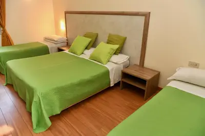 a room with two beds with lime green sheets at Hotel Anacapri in Rome