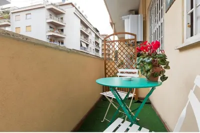 a small table on a balcony with a plant at Vatican QG Rooms in Rome