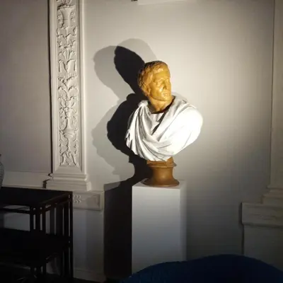 a statue of an angel sitting on a pedestal at L'obelisque maison de luxe in Rome
