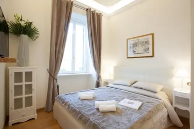 a bedroom with a bed with two towels on it at InnsideRome in Rome