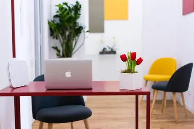 a red table with a laptop on it in a room at Suite Cardinale in Rome